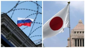 Флаг России за колючей проволокой и флаг Японии возле здания парламента