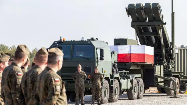 Польські військові біля пускової установки Patriot з прапором країни